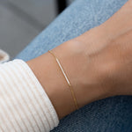 model wearing dainty gold pave bar bracelet