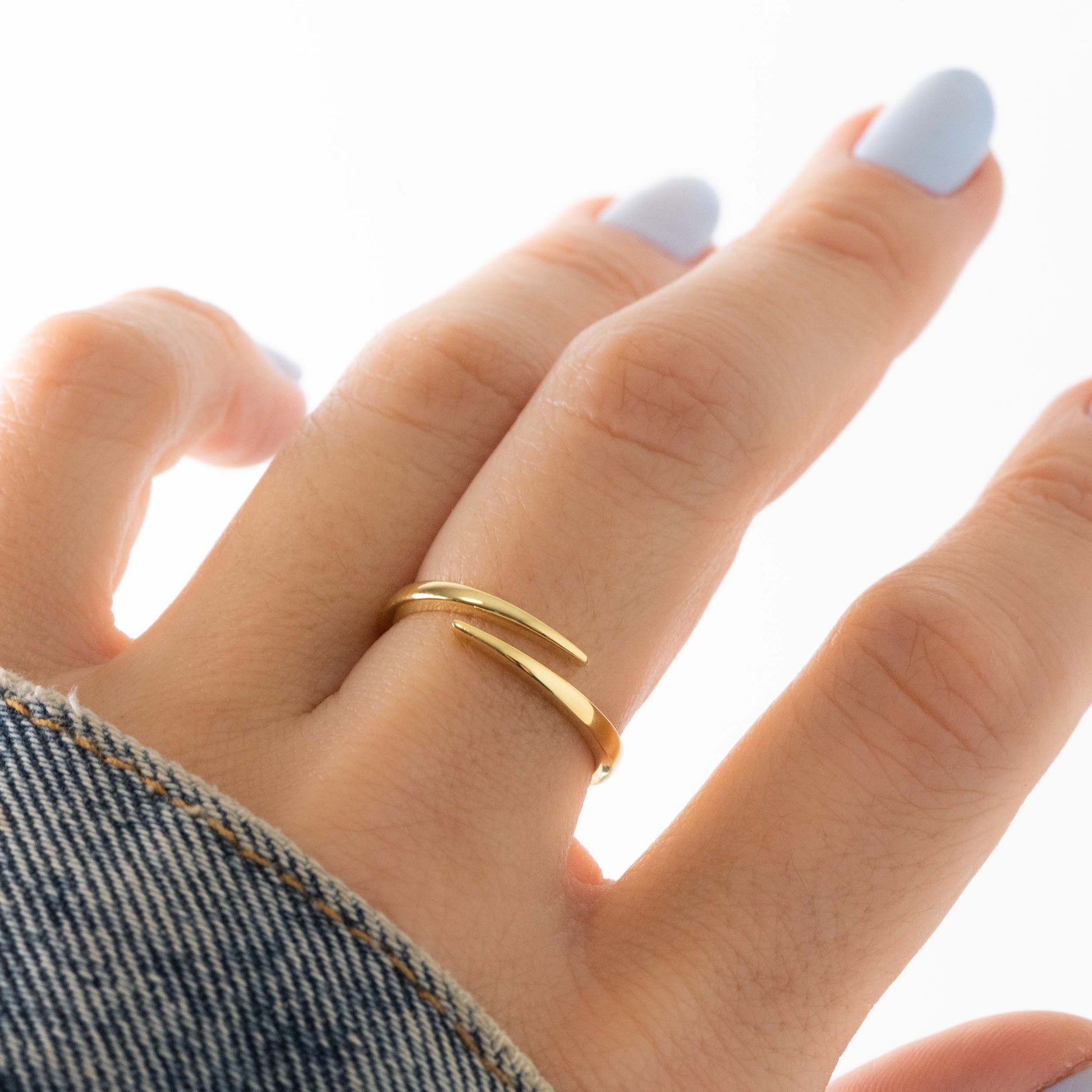 model wearing chic spiral design gold ring