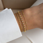 dainty gold stacking bracelet set featuring a minimalist baguette & solitaire bracelet