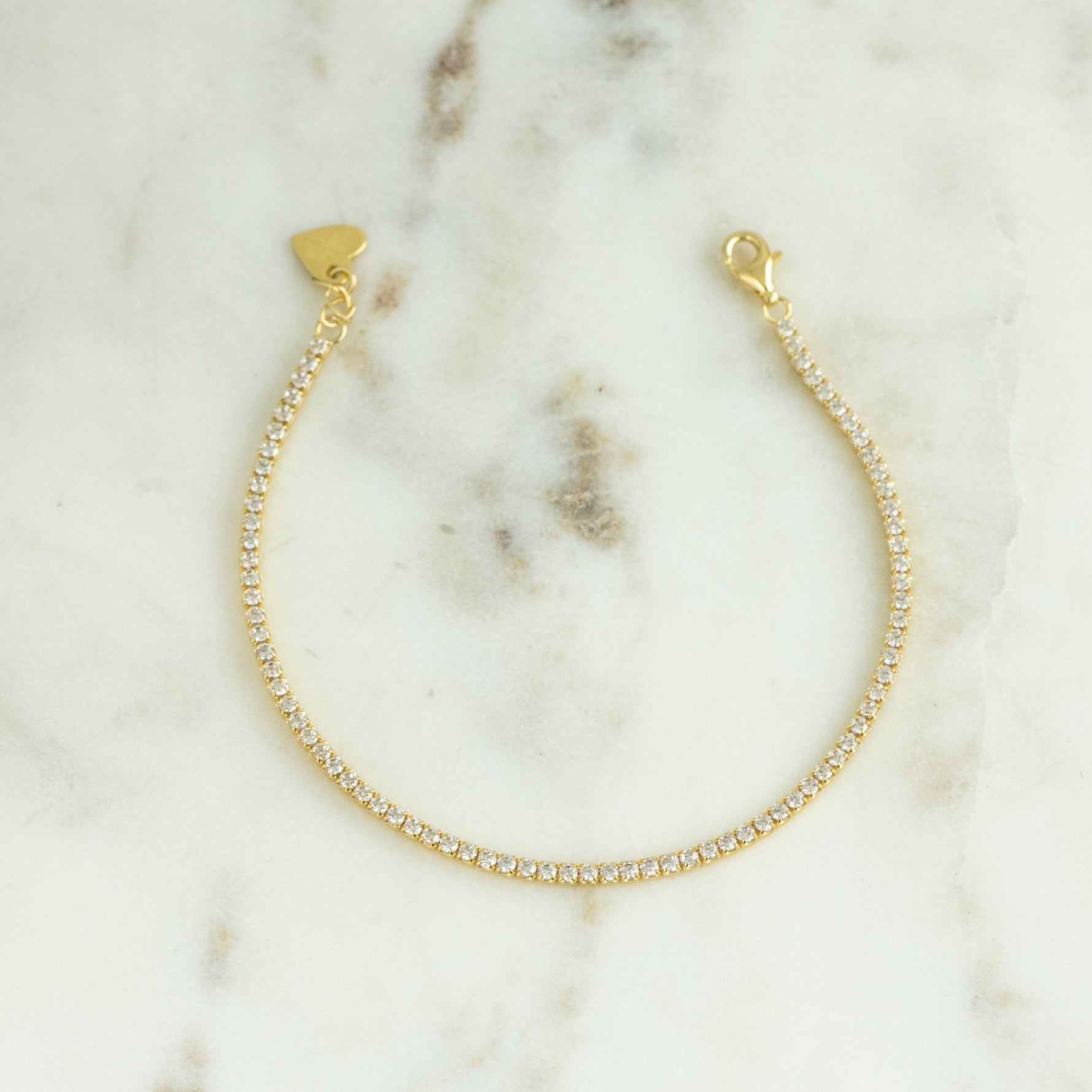 Detailed shot of the minimalist 1.75mm Tennis Bracelet, featuring brilliant cubic zirconia stones in a classic setting.