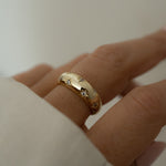 Dome ring with tiny CZ stars in 14k gold plated sterling silver, showcased on model for a chic look