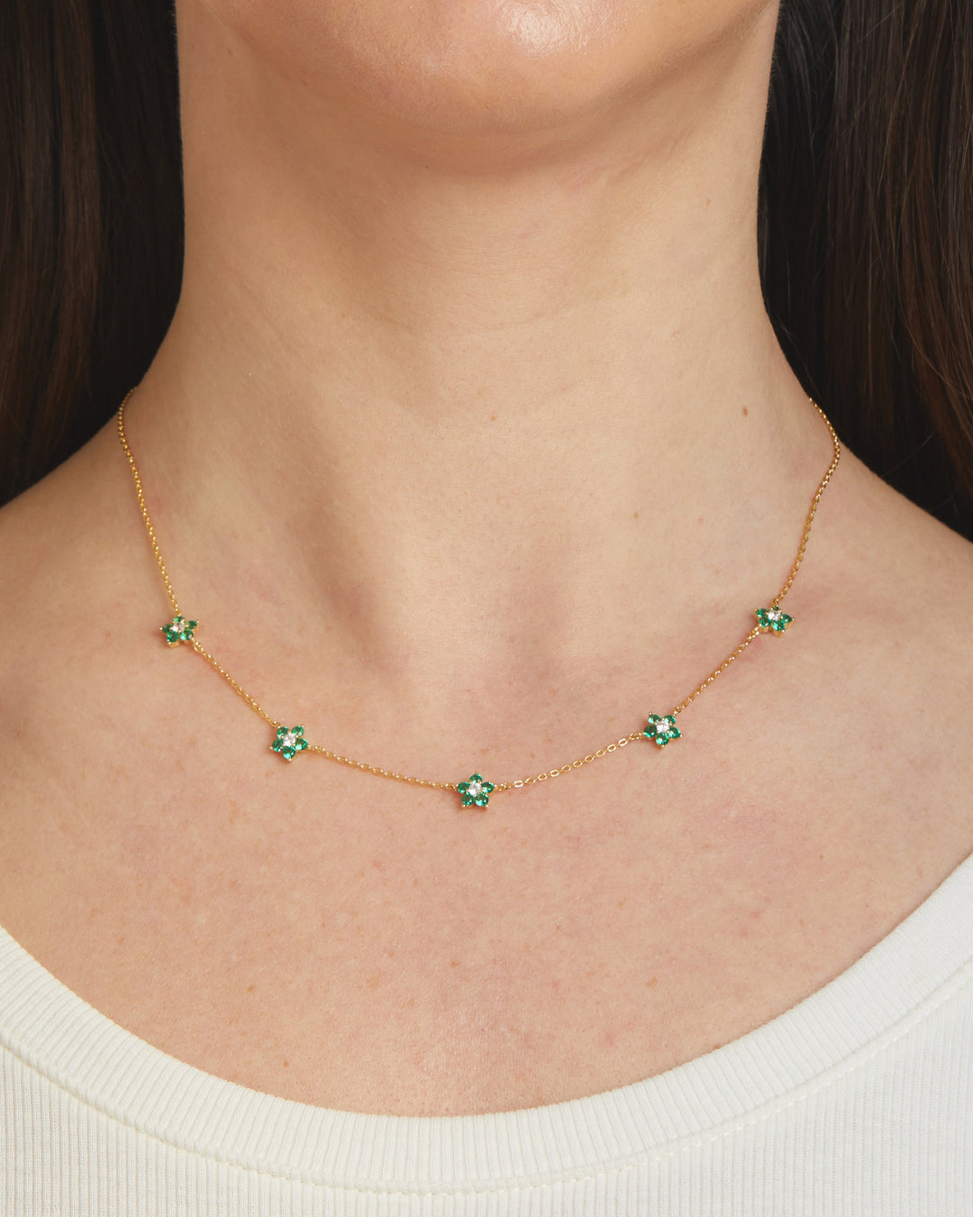 Emerald flower necklace by Sami Jewels featuring a delicate green gemstone pendant on a fine chain.