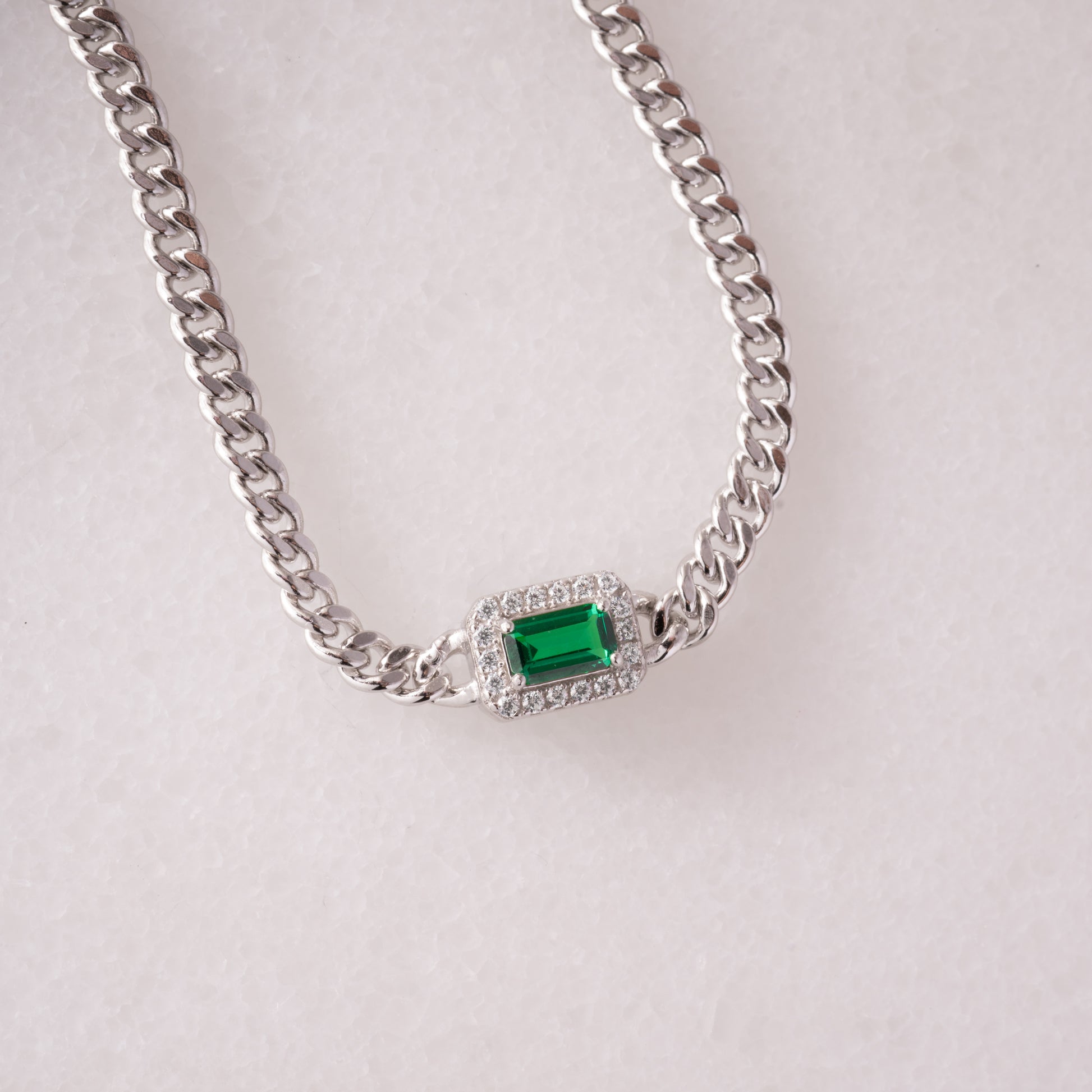 silver curb chain bracelet with emerald and diamond charm