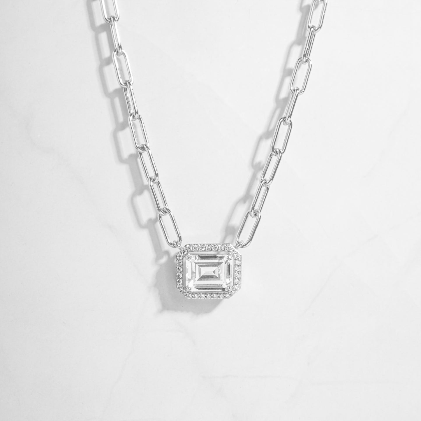 a necklace with a baguette pendant on a chain