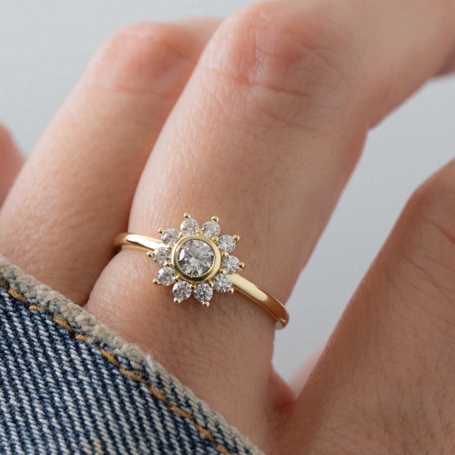 Gold flower ring with diamond accents from Sami Jewels, featuring intricate floral design on a polished band.