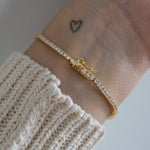 tennis bracelet with secure latch closure on model