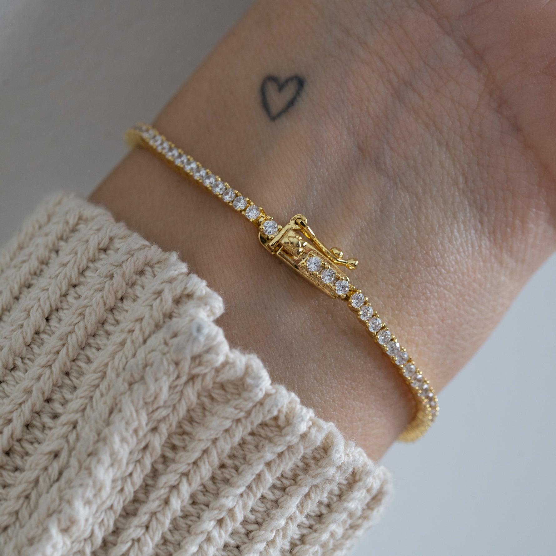 tennis bracelet with secure latch closure on model