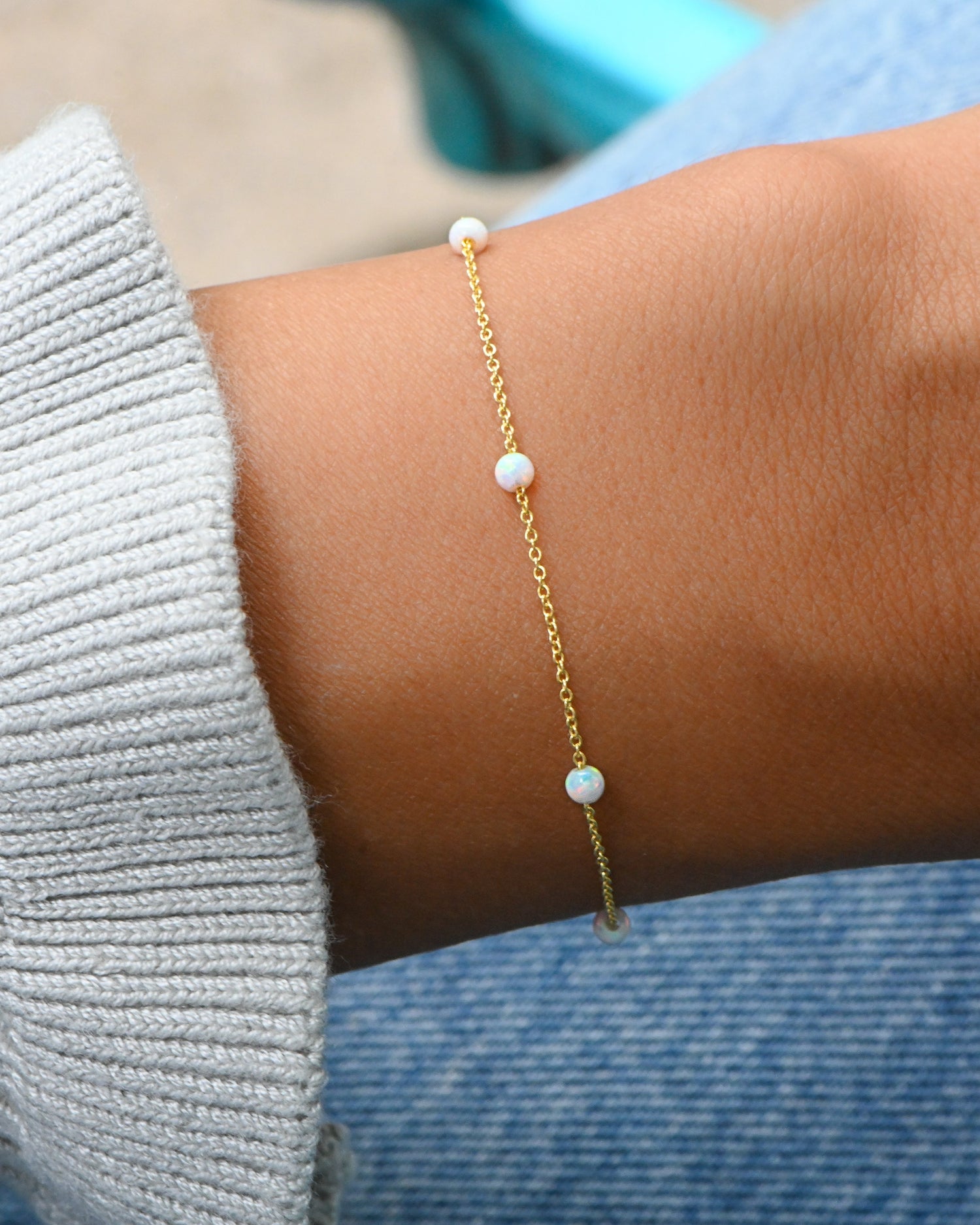 model wearing gold opal beaded bracelet