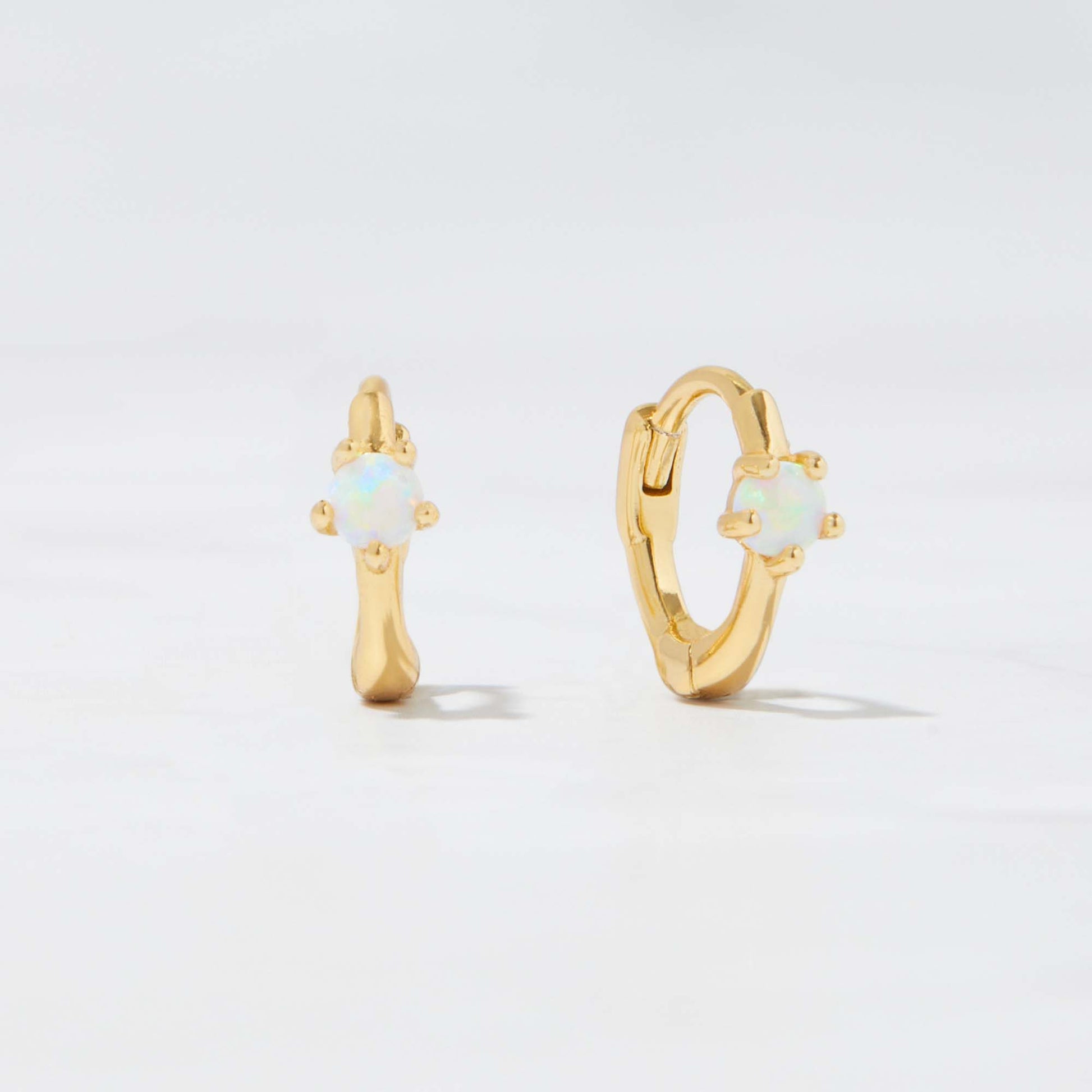 Dainty Opal Huggie Earrings on white background shown in 14k gold plated finish