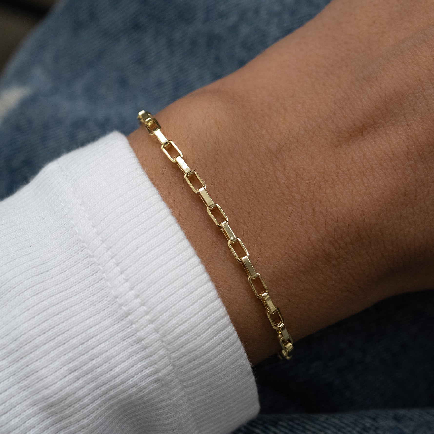 model wearing gold paperclip bracelet