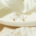 closeup image of gold petal stud earrings
