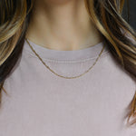 model wearing gold paperclip necklace 