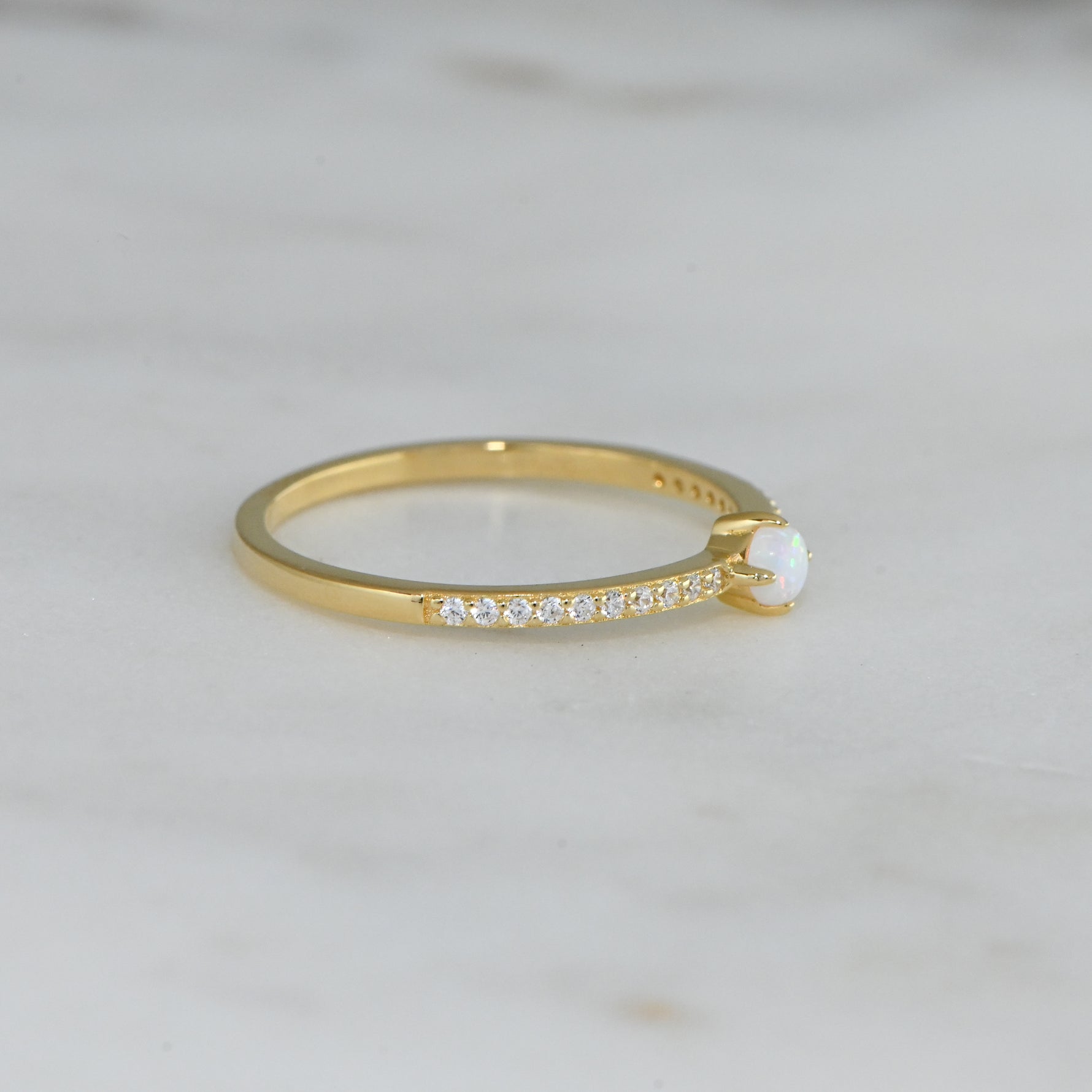 side view of cubic zirconia ring with solitaire opal stone