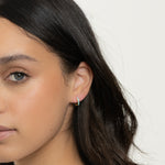 model wearing simple dainty turquoise huggie hoops