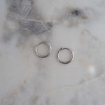 Sterling Silver huggie earrings on marble