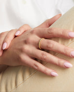 model wearing gold stacking ring 