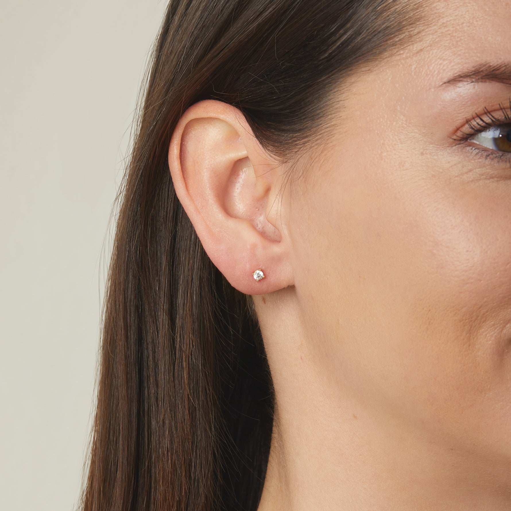 Simple, minimalist solitaire cubic zirconia stud earrings on model