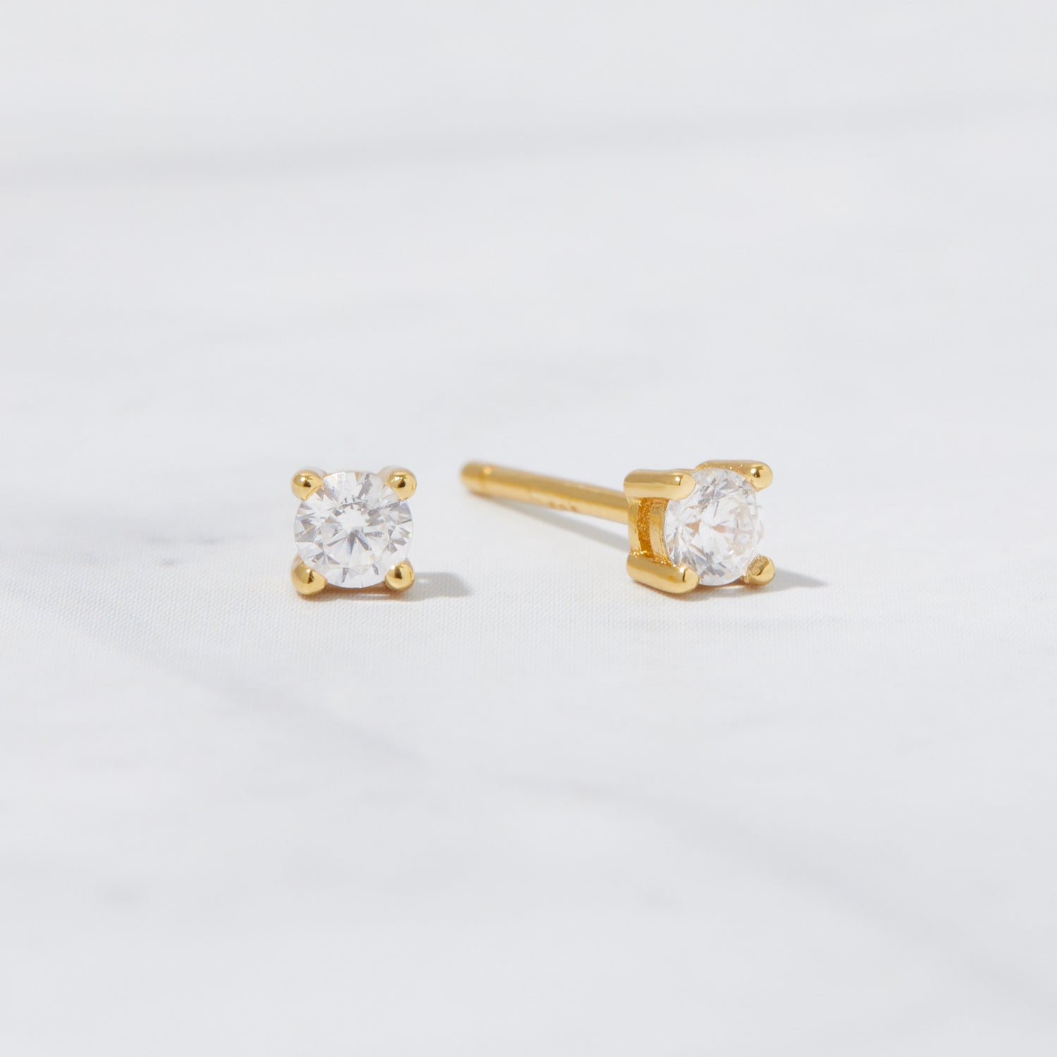 Solitaire 14k Gold Plated Sterling Silver Stud Earrings on white background