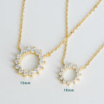 Detailed view of sunburst necklace on delicate chain, showing 10mm and 15mm pendant size
